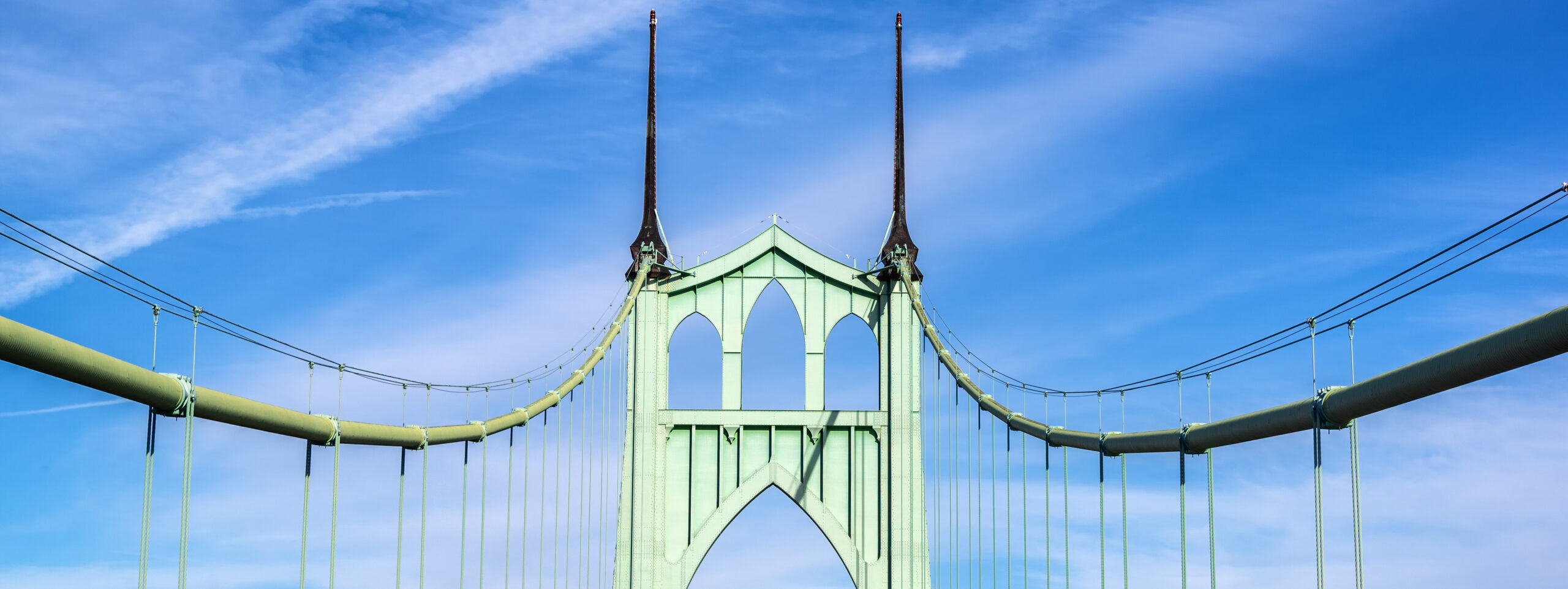Top view of the St. Johns Bridge with a bright blue sky background