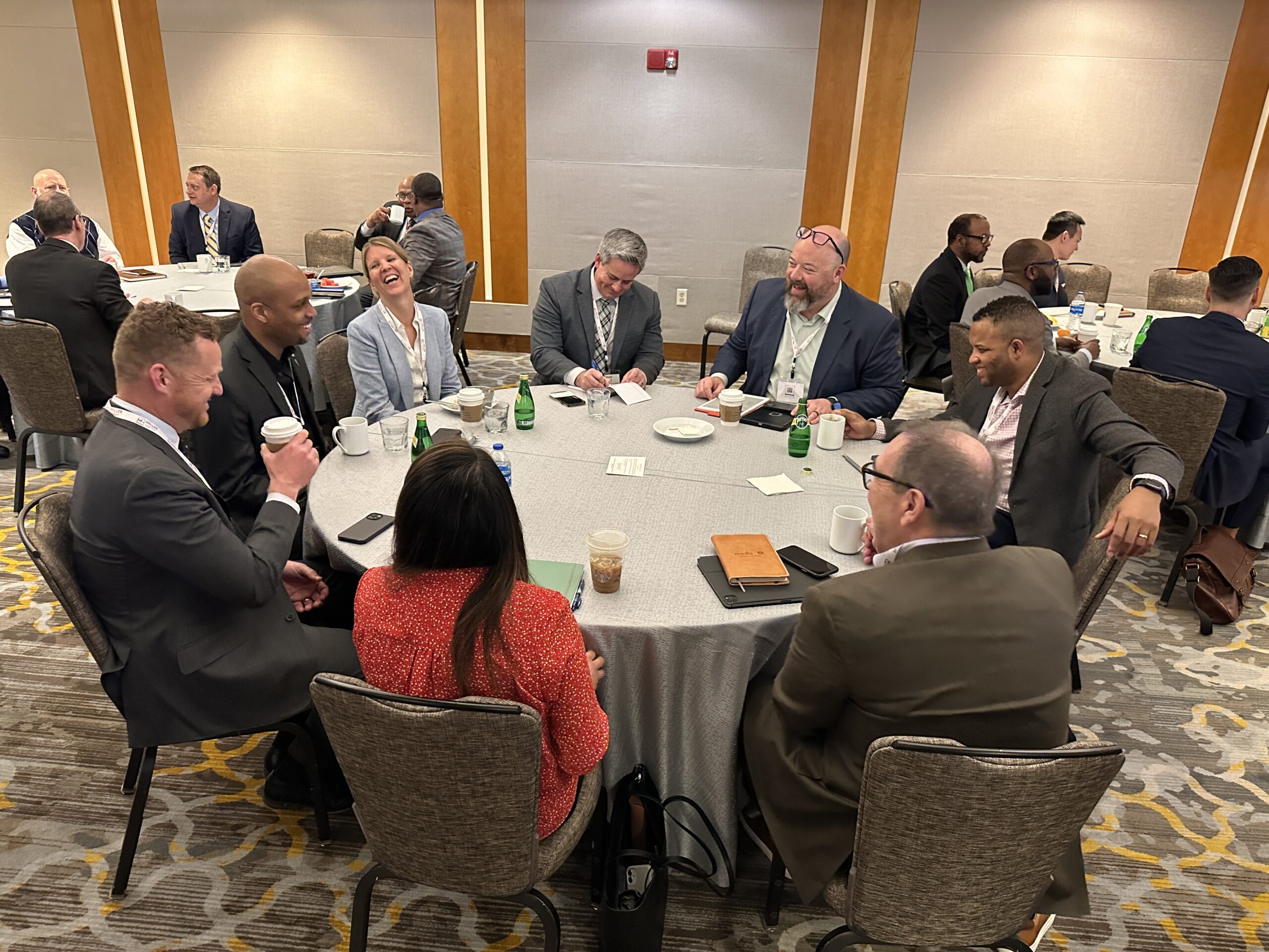 Chamber members talking around a circular table.