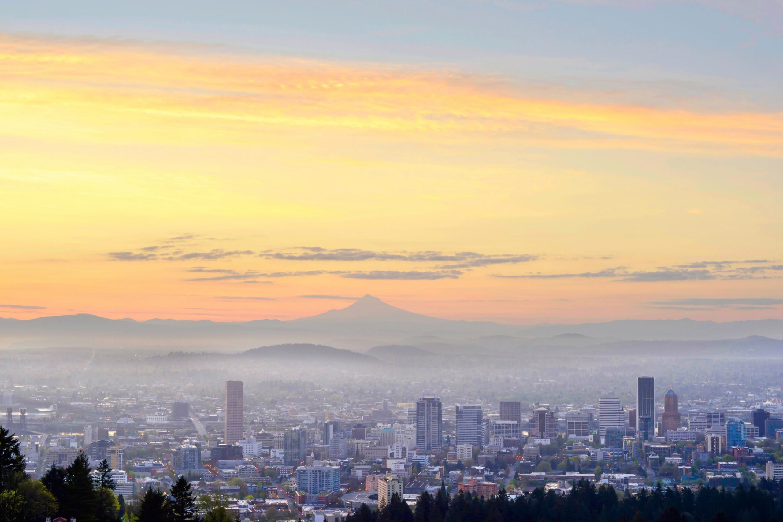 Portland cityscape with yellow pink sky and Mt. Hood.