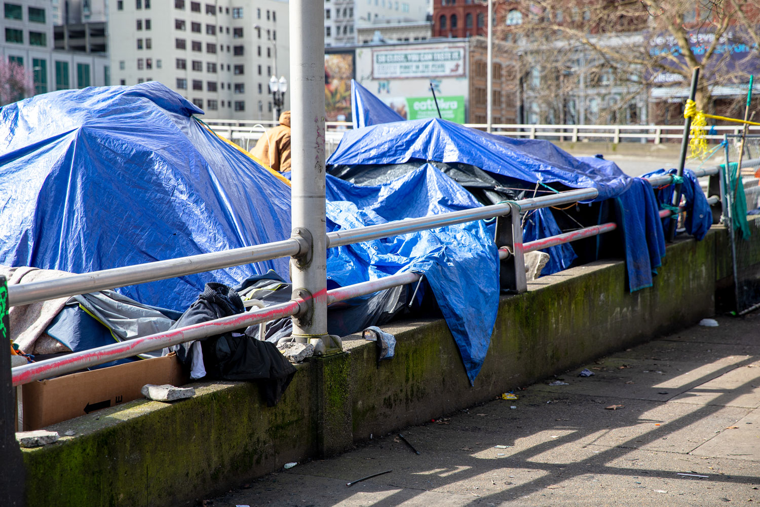 tents covered in tarps near bridge